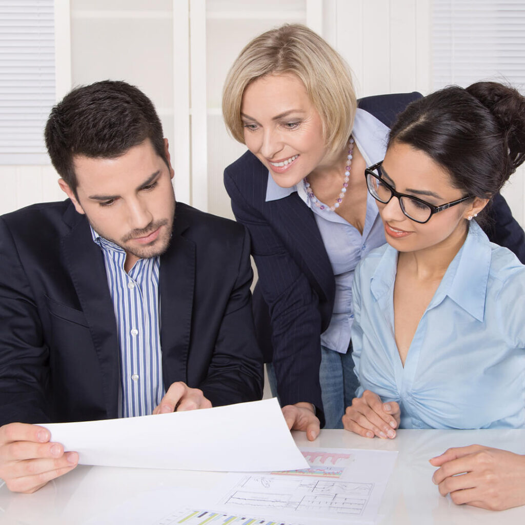 people looking at paperwork